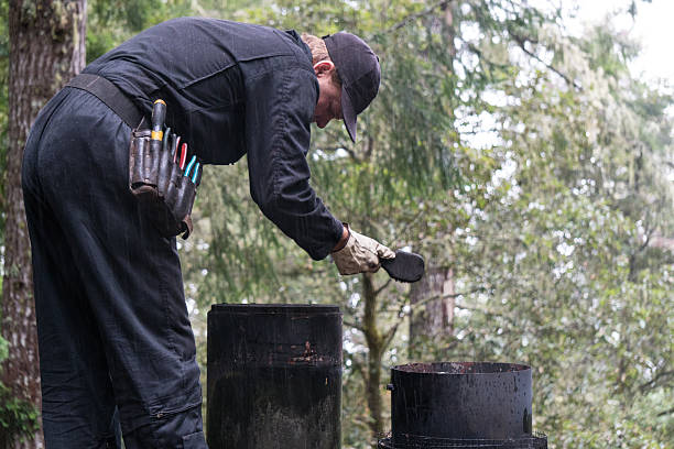 Chimney Sweep cleaning  on roof of house cleaning dirty chimney